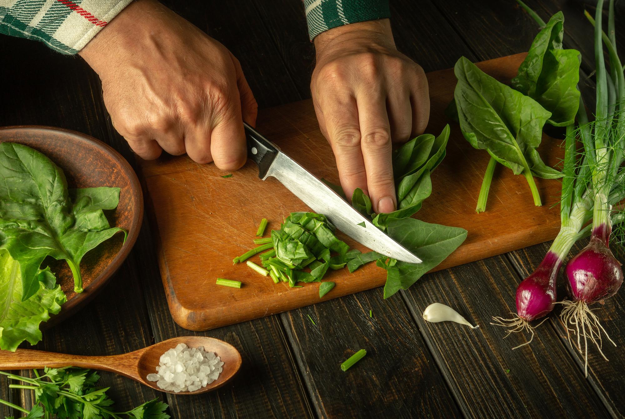Hands chopping herbs